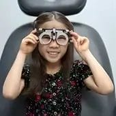 Young girl smiling after eye exam